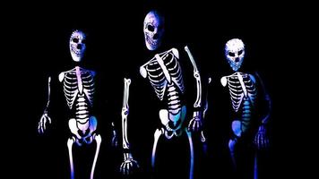 three funky disco Halloween characters dance together in skeleton costumes video