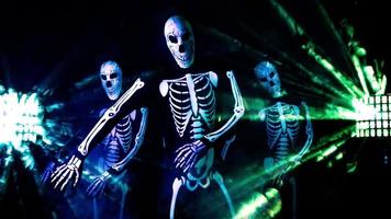 three funky disco Halloween characters dance together in skeleton costumes video