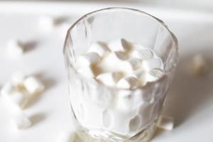 marshmallow in a glass of milk. marshmallows on a white background photo