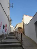 neglected street in a spanish town with stairs and graffiti on the walls of dilapidated buildings photo