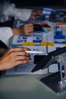 Close up ux developer and ui designer brainstorming about mobile app interface wireframe design on table with customer breif and color code at modern office.Creative digital development agency photo