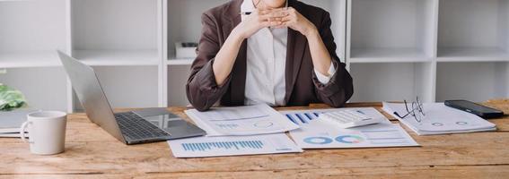 Businesswoman or accountant working Financial investment on calculator, calculate, analyze business and marketing growth on financial document data graph, Accounting, Economic, commercial concept. photo