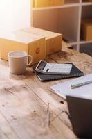 Entrepreneurs Small Business SME Independent men work at home Use smartphones and laptops for commercial checking, online marketing, packing boxes, SME sellers, concept, e-commerce team, online sales photo