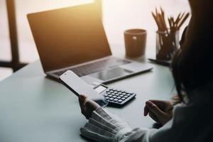 Group of confident business people point to graphs and charts to analyze market data, balance sheet, account, net profit to plan new sales strategies to increase production capacity. photo