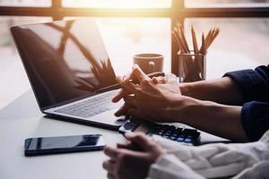 Group of confident business people point to graphs and charts to analyze market data, balance sheet, account, net profit to plan new sales strategies to increase production capacity. photo