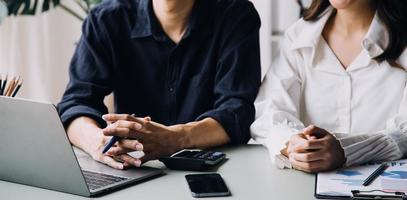 Group of confident business people point to graphs and charts to analyze market data, balance sheet, account, net profit to plan new sales strategies to increase production capacity. photo