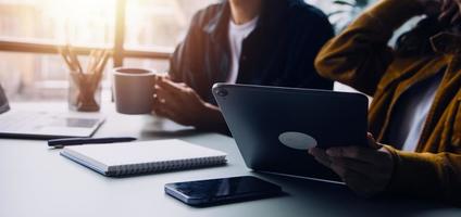 Group of confident business people point to graphs and charts to analyze market data, balance sheet, account, net profit to plan new sales strategies to increase production capacity. photo