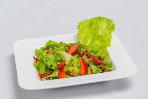 Colorful delicious Strawberry lettuce Salad with Strawberry Balsamic Dressing. Top View and Closeup views. photo