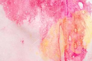 Abstract pink watercolor paint on paper background photo