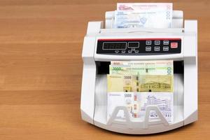 Malawian money - new series of banknotes in the counting machine photo