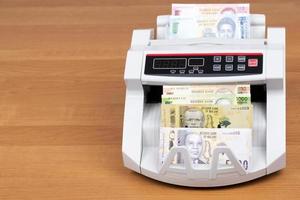 Malawian money - new series of banknotes in the counting machine photo