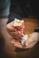 tasty cold creamy vanilla ice cream in a red sugar cone held in your hand photo