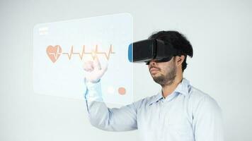 Businessman using  VR glasses with cardiogram on white background photo