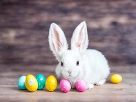 Easter bunny with easter eggs on a wooden table photo