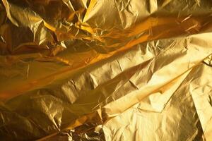 Design space gold crumpled foil paper textured background. photo