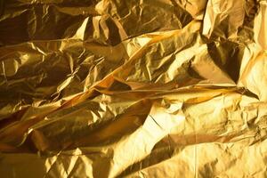 Design space gold crumpled foil paper textured background. photo