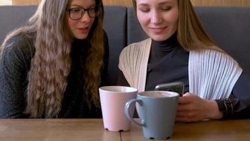 Group of people use mobile phones in a cafe instead of communicating with each other video