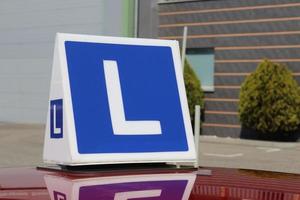 Driving school car. L sign. Driving lessons car. Learning how to drive a car. photo