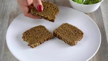 Spreading mashed avocado on toast and sprinkle with salt and spices. Healthy vegan breakfast. video