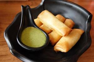 Fried mozzarella cheese sticks with cream sauce. photo