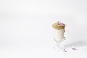 Dalgon's trending drink is coffee. Coffee mug, lilac and marshmallow on a white background. Copying space photo