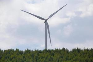 wind turbine against cloudy sky photo