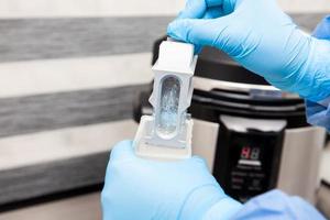 Scientist preparing slides with tissue samples for immunohistochemistry assay in the laboratory. Scientist at the Immunohistochemistry laboratory carry out antigen retrieval on biopsy tissue. photo