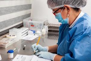 Laboratorian giving admission to pap smear samples in the laboratory for analysis. Scientist receiving patient samples for laboratory for analysis. Cervical cancer concept. Medical concept. photo