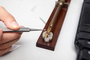 Transmission electron microscope sample holder been loaded with an specimen on a grid photo