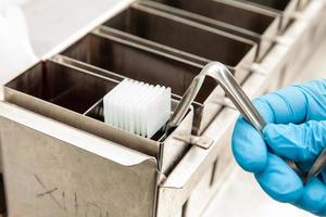 Scientist dewaxing paraffin embedded tissue samples in the laboratory. Xylene-based removal of paraffin. photo
