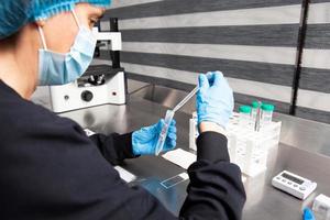 Female scientist preparing slides for karyotipe and fluorescence in situ hybridization - FISH in the laboratory photo