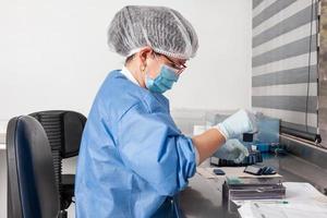 Laboratorian giving admission to pap smear samples in the laboratory for analysis. Scientist receiving patient samples for laboratory for analysis. Cervical cancer concept. Medical concept. photo