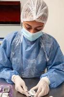 Scientist preparing paraffin blocks containing biopsy tissue for sectioning. Pathology laboratory. Cancer diagnosis. photo