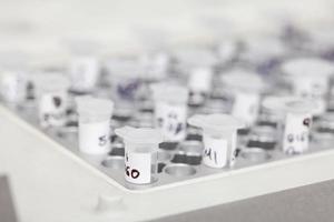 Closeup of test tubes at a thermal cycler block in a molecular biology laboratory. Polymerase chain reaction technique. PCR technique photo