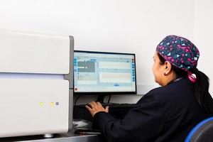 Female scientist working at the laboratory with a thermal cycler. Real-time polymerase chain reaction technique. RT-PCR technique photo