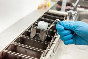 Scientist dewaxing paraffin embedded tissue samples in the laboratory. Xylene-based removal of paraffin. photo