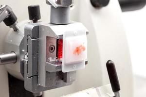 Paraffin-embedded specimen on a rotary microtome ready to be cut to obtain sections for pathology studies. photo
