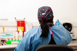 Female scientist extracting DNA using the spin column-based nucleic acid purification technique photo