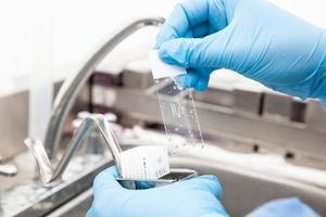 Scientist showing a dewaxed tissue samples in the laboratory. Xylene-based removal of paraffin. photo