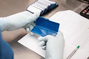 Laboratorian giving admission to pap smear samples in the laboratory for analysis. Scientist receiving patient samples for laboratory for analysis. Cervical cancer concept. Medical concept. photo