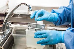 Scientist preparing slides with tissue samples for immunohistochemistry assay in the laboratory. photo