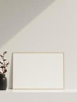 Empty poster frame mockup in sunlight with shadow and vase photo