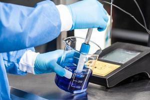 Scientist using a ph meter at laboratory photo