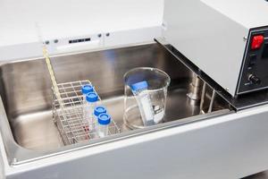 Falcon tubes and rack in a hot water bath at laboratory photo