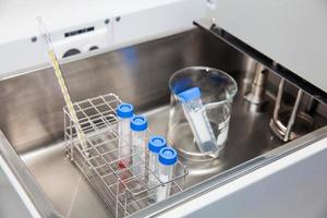 Falcon tubes and rack in a hot water bath at laboratory photo