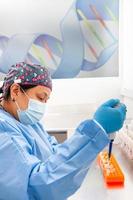 Female scientist extracting DNA using the spin column-based nucleic acid purification technique photo