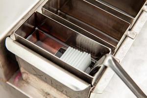 Scientist dewaxing paraffin embedded tissue samples in the laboratory. Xylene-based removal of paraffin. photo