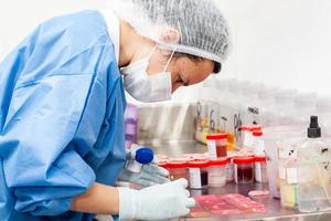 Scientist processing biopsy samples at the pathology laboratory to be embedded in paraffin for analysis. Cancer diagnosis concept. Medical concept. photo