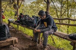 Man got journey on the forest going to peak mountain on Semarang Central Java. The photo is suitable to use for adventure content media, nature poster and forest background.