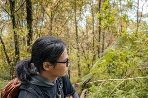 Man got journey on the forest going to peak mountain on Semarang Central Java. The photo is suitable to use for adventure content media, nature poster and forest background.